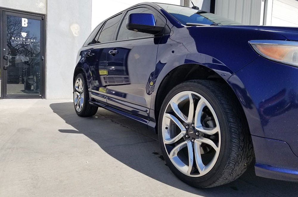 Car in front of Black Cat Paint and Body