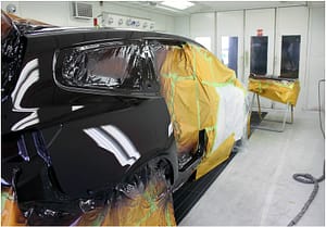 Car being repaired in spray booth