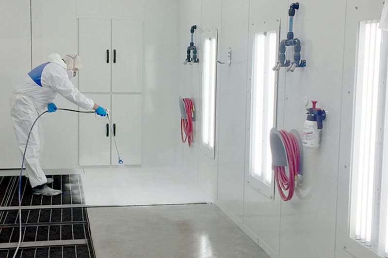 Applying Booth Shield to paint booth walls and floor