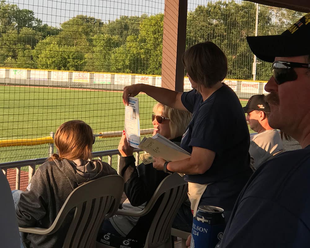 Crowd of people spectating a GFS softball event
