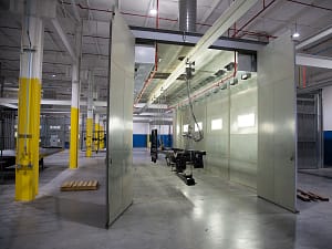 Industrial paint booth with conveyor