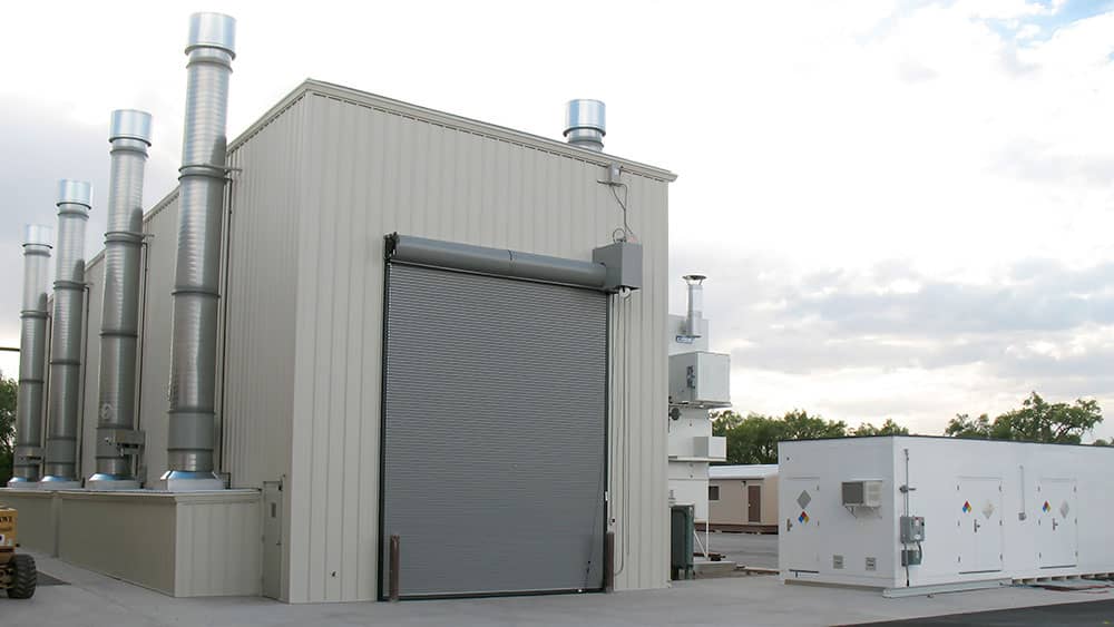 Custom industrial outdoor paint booth with Hazmat Storage building